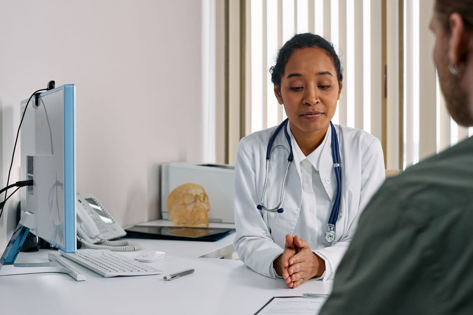 A doctor talking with a patient during a consultation at a small clinic