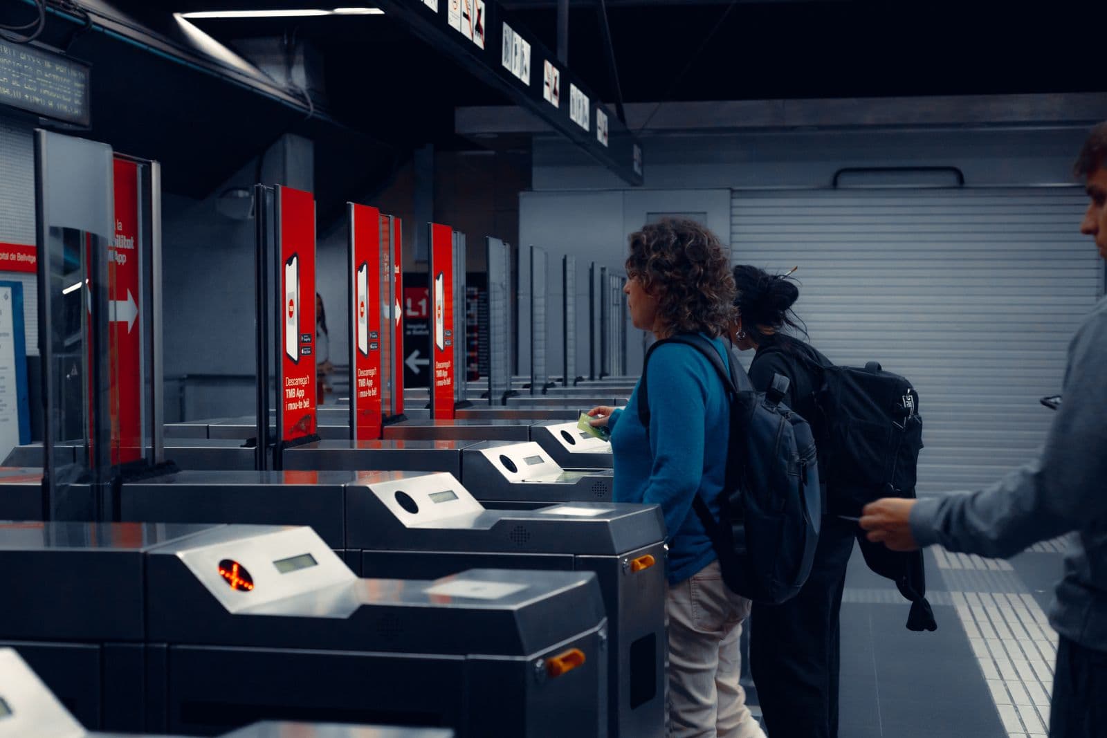 Commuters tapping transit cards at ticket gates in a Seoul subway station